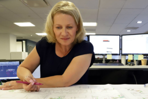 A Woman Working on a Sheet of Paper